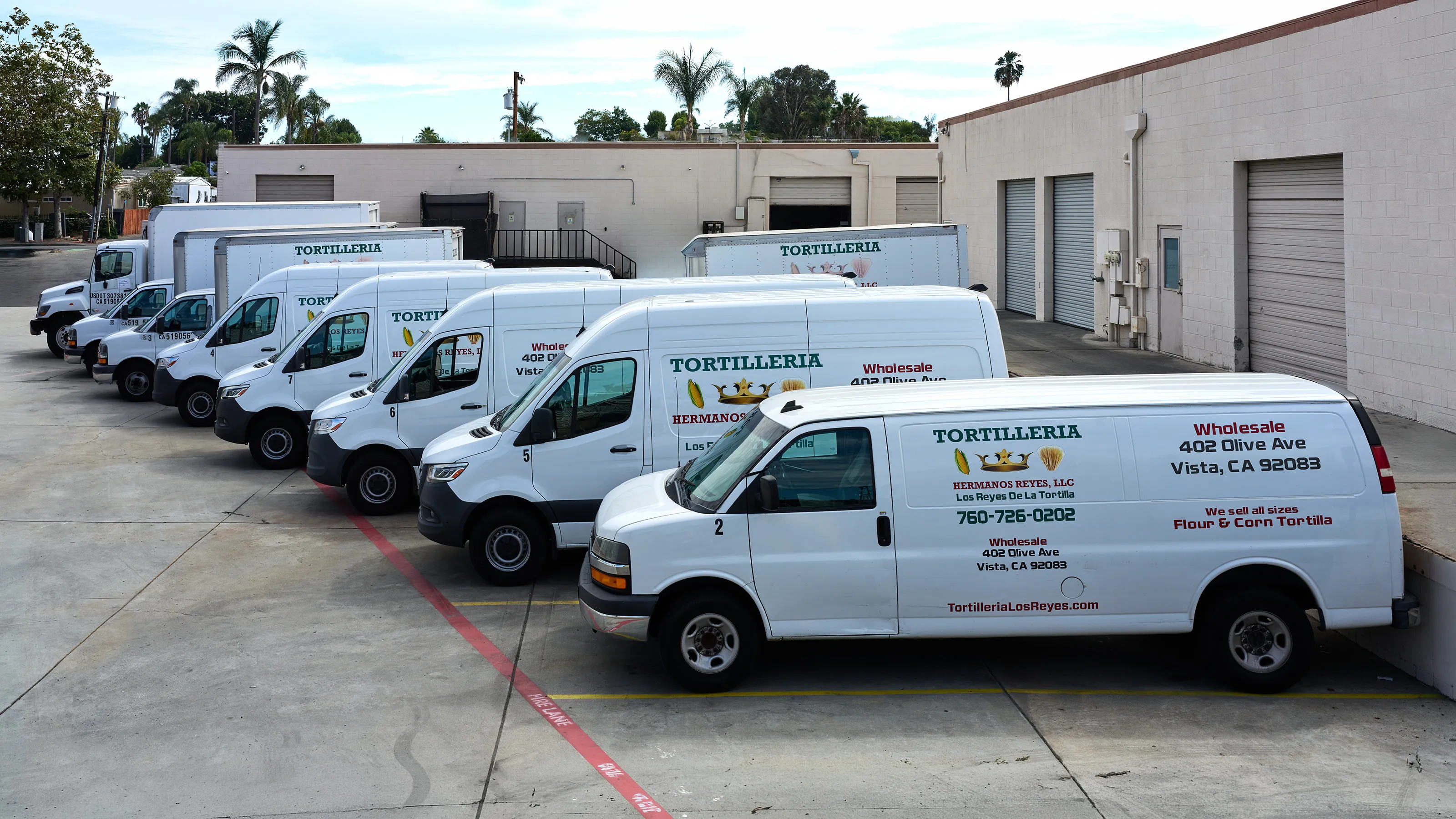 The company vans parked outside the tortillería